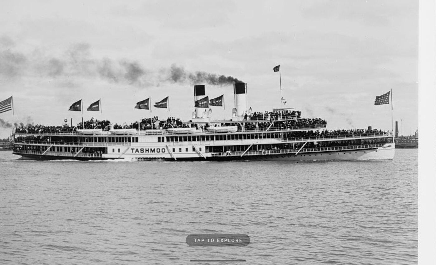 Attract screen showing a historical photograph of an excursion steamer, with a 'Tap to explore' button.