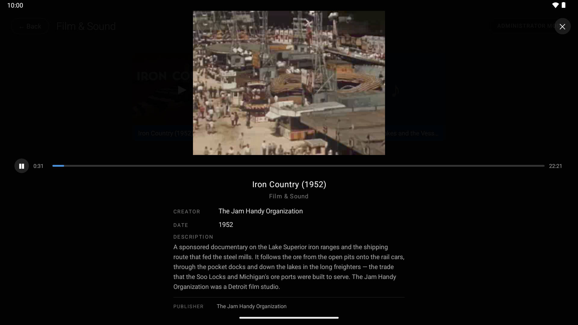 A film playing full screen inside the detail view, with a scrub bar and the film's record below.